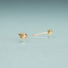 Load image into Gallery viewer, Gold shell-shaped earrings on a light blue background