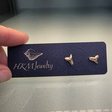Load image into Gallery viewer, Two gold sharks teeth earrings on a black card with 'HKM Jewelry' branding.