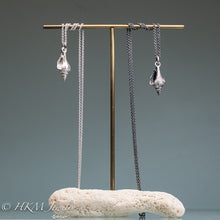 Load image into Gallery viewer, florida fighting conch shell necklaces in oxidized and polished sterling silver on brass and coral jewelry display by hkm jewelry