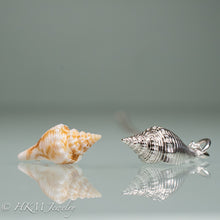 Load image into Gallery viewer, side view of fl fighting conch shell and cast silver replica by hkm jewelry