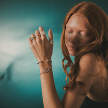 Load image into Gallery viewer, Female, red-head, starfish ring, wavy stacking ring, limpet ring, kitten’s paw ring, viking rope cuff, life saver cuff, green/blue, teal, underwater background