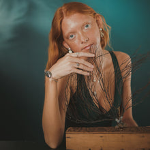 Load image into Gallery viewer, Female, red-head, lion’s paw pearl earrings, oyster seed cuff, sea tail ring, limpet ring, green/blue, teal, underwater background