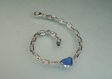 Load image into Gallery viewer, A silver chain bracelet featuring a smooth, irregular-shaped blue stone pendant, displayed on a light gray background.