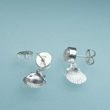 Load image into Gallery viewer, under and side view of bay scallop and pearl earrings with two tier dangle on blue background