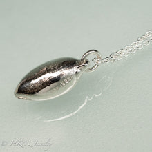 Load image into Gallery viewer, side view of cast atlantic bubble shell bulla striata necklace in polished sterling silver with makers mark HKM and hallmark 925 stamps by hkm jewelry