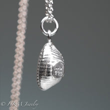 Load image into Gallery viewer, sideview of cast silver cowrie shell by hkm jewelry