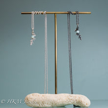 Load image into Gallery viewer, cast silver cypress bough and amazonite necklaces on brass and coral jewelry stand by hkm jewelry in polished and oxidized finish
