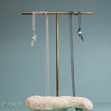 Load image into Gallery viewer, cast silver cypress bough and amazonite necklaces on brass and coral jewelry stand by hkm jewelry in polished and oxidized finish