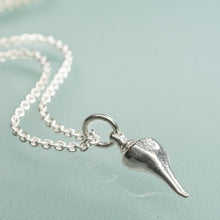 Load image into Gallery viewer, back of silver lightning whelk shell necklace on light aqua background