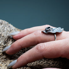 Load image into Gallery viewer, cast silver darkened metal textural ring with barnacle on hand model with textured dark teal background
