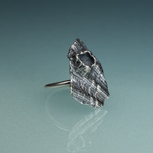 Load image into Gallery viewer, oxidized silver shell textured ring with barnacle on hand model with teal gradient background