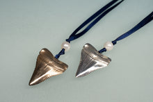 Load image into Gallery viewer, Two silver shark tooth ornaments on blue ribbons with pearls against a light gray background