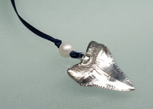Load image into Gallery viewer, Silver shark tooth ornament with a pearl on a black cord against a light gray background