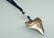 Load image into Gallery viewer, metal shark tooth pendant on a blue cord with a pearl, against a light green background