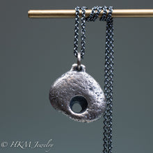 Load image into Gallery viewer, close up of hag stone necklace cast in sterling silver by hkm jewelry in oxidized finish