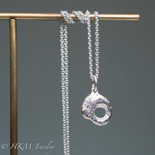 Load image into Gallery viewer, close up of hag stone necklace cast in sterling silver by hkm jewelry in polished finish