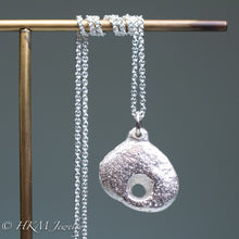 Load image into Gallery viewer, close up of hag stone necklace cast in sterling silver by hkm jewelry in polished finish