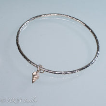 Load image into Gallery viewer, hammered silver bangle with mud snail shell charm by hkm jewelry