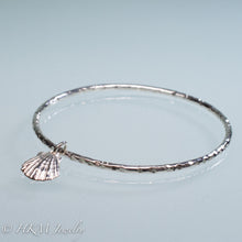 Load image into Gallery viewer, hammered silver bangle with lion&#39;s paw scallop shell charm by hkm jewelry
