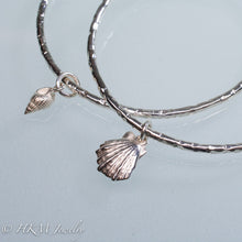 Load image into Gallery viewer, hammered silver bangles with mud snail and lion&#39;s paw shell charms by hkm jewelry
