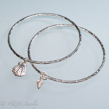 Load image into Gallery viewer, hammered silver bangles with mud snail and lion's paw shell charms by hkm jewelry