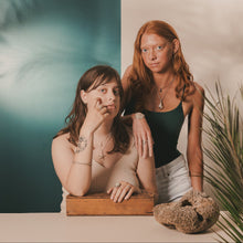 Load image into Gallery viewer, Females, Brunette and Red Head, barnacle studs and necklace, starfish ring and necklace, twisted bangle, ram’s horn ring, sand dollar cuff, knobbed whelk necklace, mini shark tooth studs, teal and beige split background