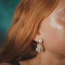 Load image into Gallery viewer, Close-up of a person wearing a shell-shaped earring with a blurred background