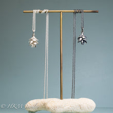 Load image into Gallery viewer, cast silver hemlock pine cone necklace by hkm jewelry in two finished on brass and coral display