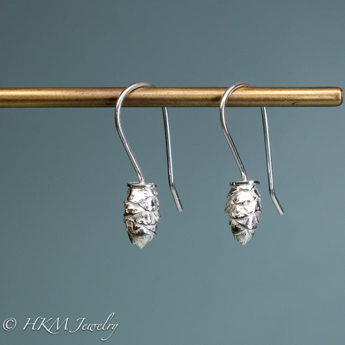side view of mini cone drop earrings in polished sterling silver by hkm jewelry