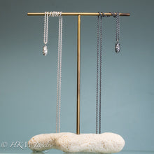 Load image into Gallery viewer, cast silver mini pinecone necklaces on brass and coral display  by hkm jewelry in oxidized and polished finish