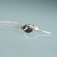 Load image into Gallery viewer, side view of mini cast silver horseshoe crab necklace by hali maclaren of hkm jewelry laying on blue background