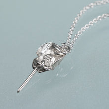 Load image into Gallery viewer, underside view of HKM makersmark and Hallmark .925 of the mini cast silver horseshoe crab necklace by hali maclaren of hkm jewelry laying on blue background