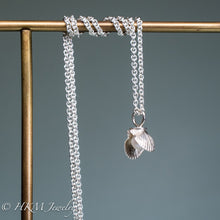 Load image into Gallery viewer, mini bay scallop necklace with pearl on brass jewelry display by hkm jewelry