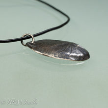 Load image into Gallery viewer, Naticidae moon snail operculum cast in sterling silver on leather cord by hkm jewelry