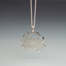 Load image into Gallery viewer, Silver crab pendant necklace on a gray background