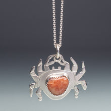 Load image into Gallery viewer, Silver crab pendant with a red stone on a gray background