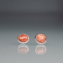 Load image into Gallery viewer, Pair of silver earrings with red stone on a gray background