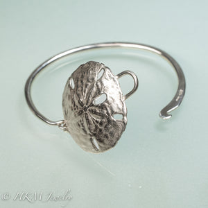 open clasp of sand dollar cuff in silver by hkm jewelry