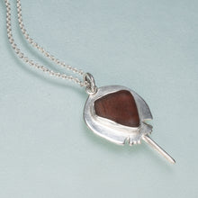 Load image into Gallery viewer, Silver pendant with a brown stone on a light blue background