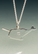 Load image into Gallery viewer, A sterling silver narwhal pendant necklace on a matching ball chain, displayed against a dark-to-light gradient background. The pendant features a sterling silver narwhal with a twisted horn and '925' purity stamp.