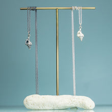 Load image into Gallery viewer, Thick-lip drill snail shell necklaces cast in sterling silver polished and oxidized finish by hkm jewelry on brass and coral jewelry display stand