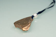 Load image into Gallery viewer, Bronze leaf-shaped pendant on a blue cord with a pearl, against a light gray background