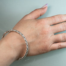 Load image into Gallery viewer, modeling the sterling silver twist rope bangle by hkm jewelry