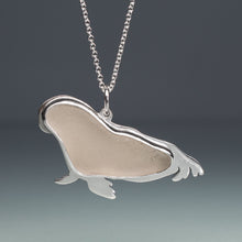 Load image into Gallery viewer, Silver pendant shaped like a seal on a chain against a gradient gray background