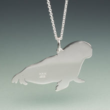 Load image into Gallery viewer, Silver pendant shaped like a sea lion on a chain against a gradient background