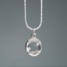 Load image into Gallery viewer, Silver necklace with a clear cape may diamond pendant on a gray background