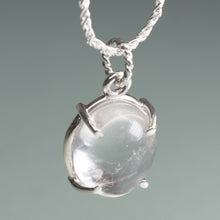Load image into Gallery viewer, Silver pendant with a clear stone on a gray background