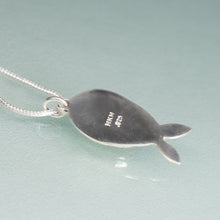 Load image into Gallery viewer, Silver fish-shaped pendant on a light blue background