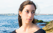Load image into Gallery viewer, Caryle modeling the auger snail shell earrings by hkm jewelry