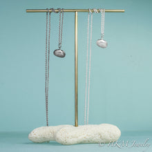 Load image into Gallery viewer, to scale view of ark clam shell necklace in polished and oxidized silver by hkm jewelry in sterling silver